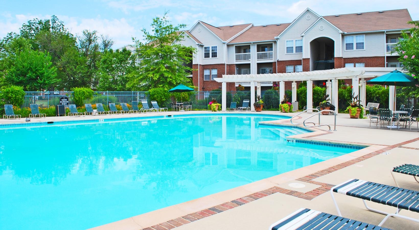 Sparkling swimming pool with lounge seating and umbrellas