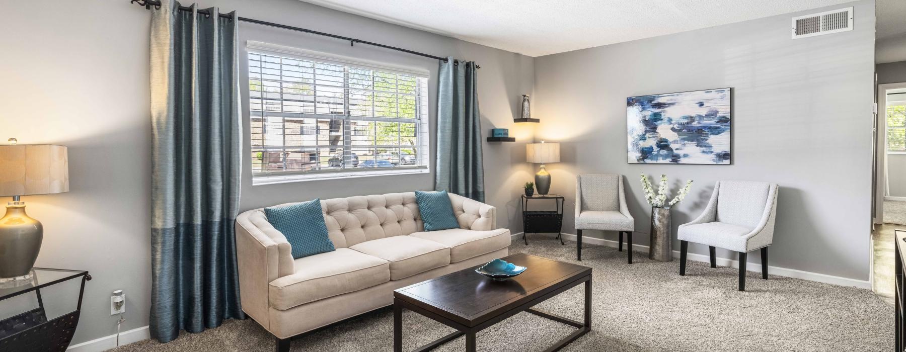 a living room with a couch and chairs