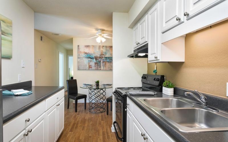 a kitchen with white cabinets