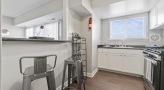 Kitchen with stainless steel appliances and breakfast bar