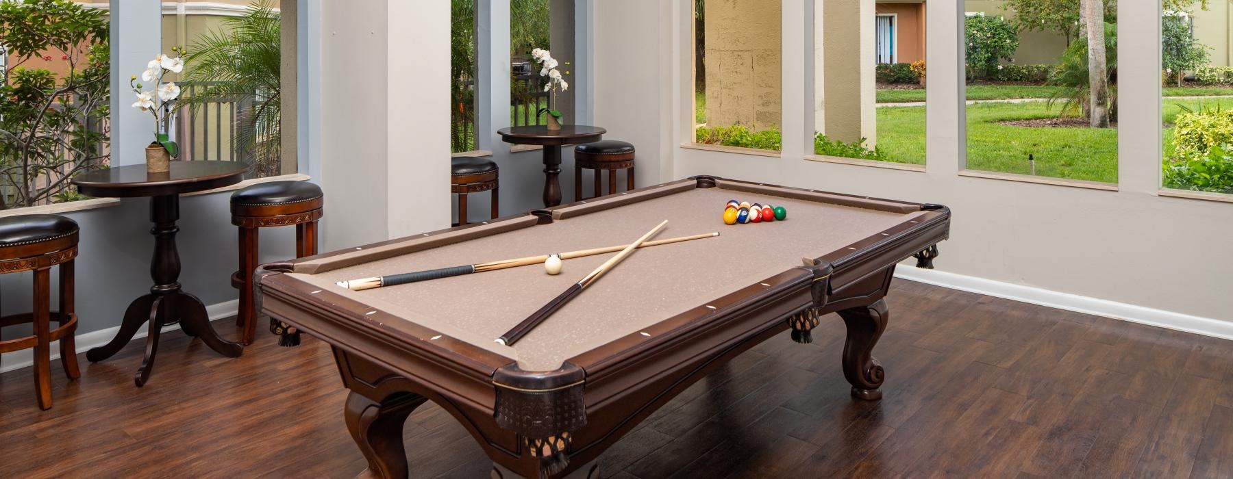 a clubroom with a pool table and chairs