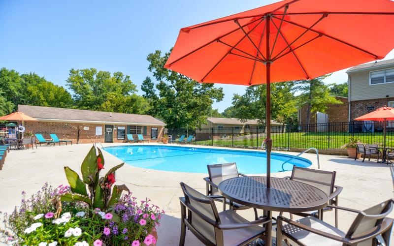 a pool with a table and chairs next to it