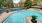 Sparkling pool and central tennis and sports courts