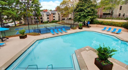 Sparkling pool and central tennis and sports courts
