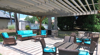 Grill area with lounge furniture covered by pergola