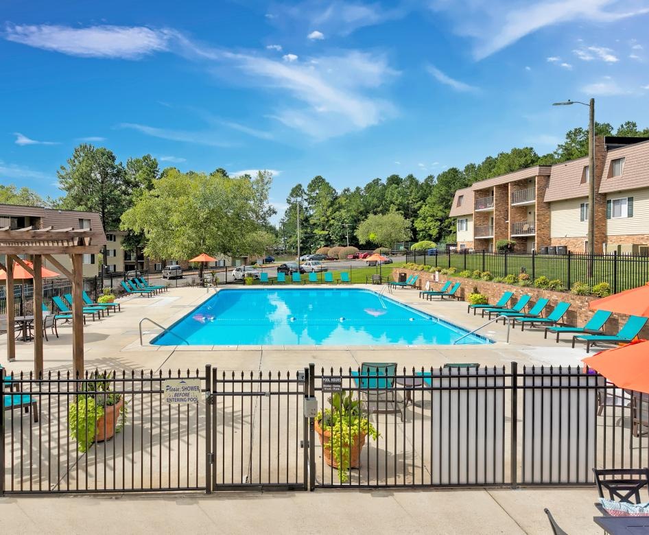 a swimming pool with chairs around it