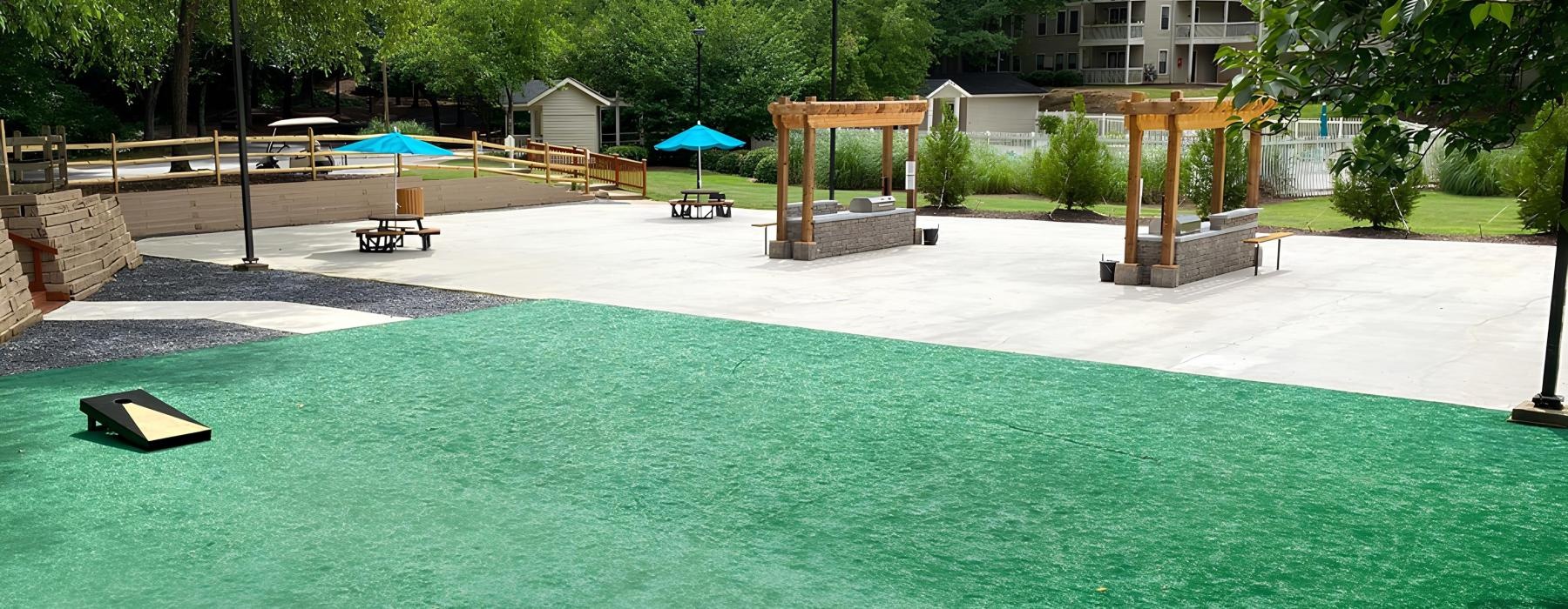 a courtyard with a cornhole area