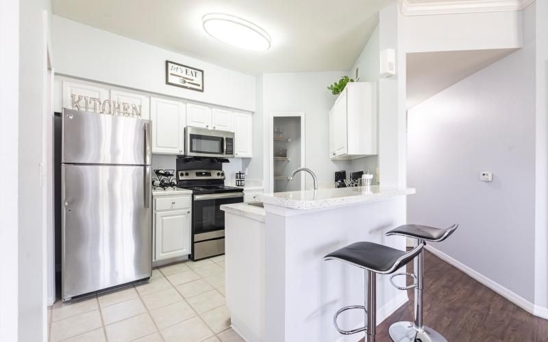 a kitchen with white cabinets