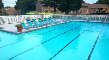 Olympic sized swimming pool with lounge chairs on the deck