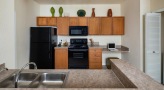Spacious kitchen with sleek black appliances and built in microwave