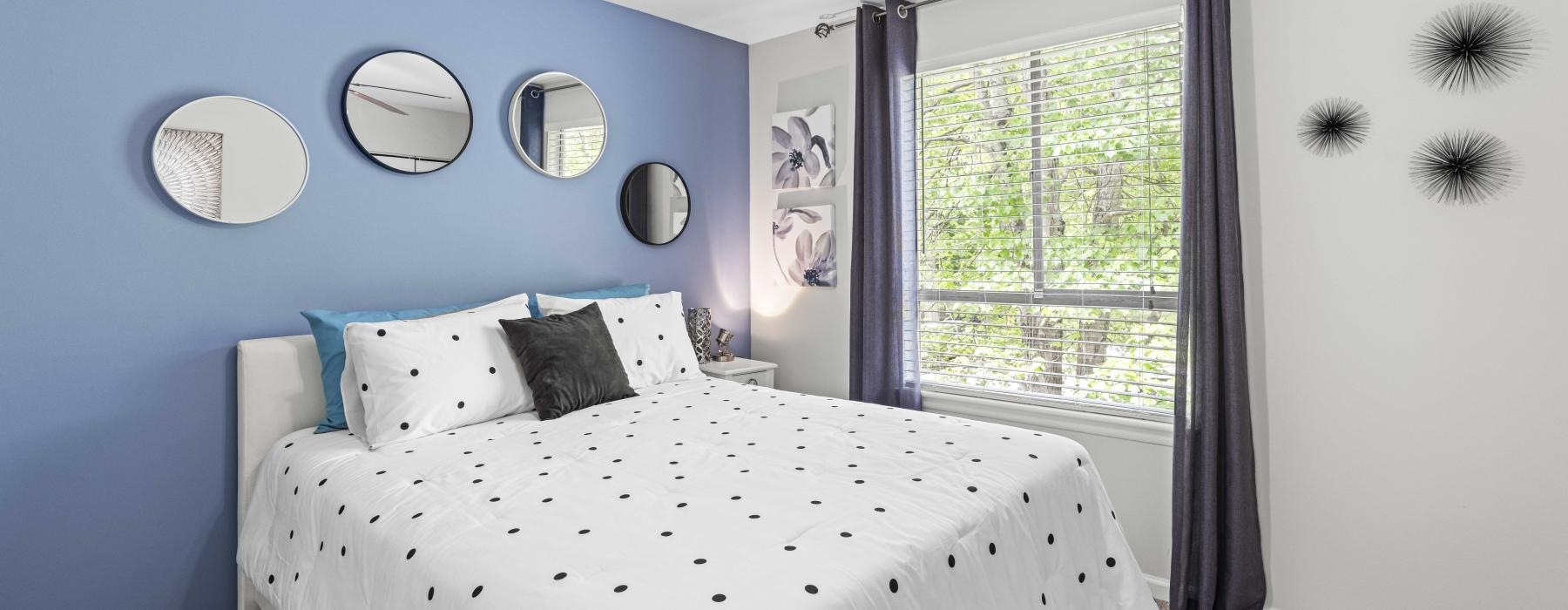 a bedroom with a fan and a bed