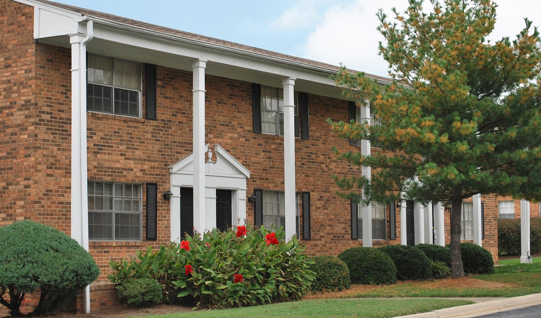 a brick building with a white column