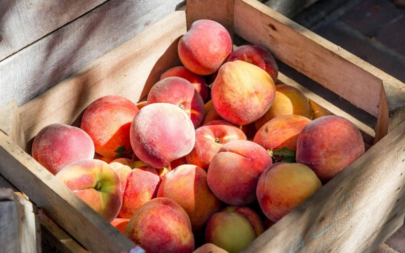 a crate full of peaches