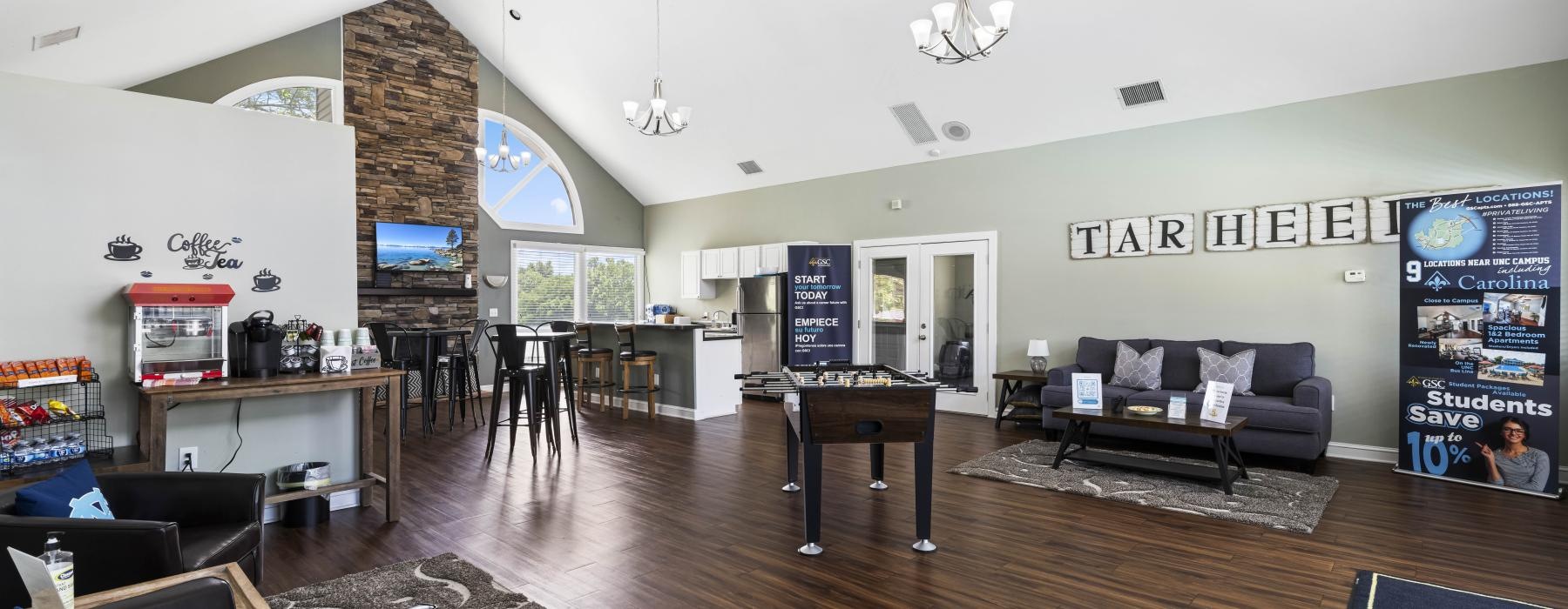 a clubroom with games, a tv and couches