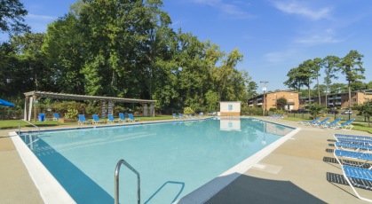 Swimming pool with lounge seating and umbrellas