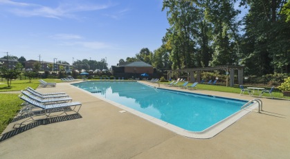 Swimming pool with lounge seating and umbrellas
