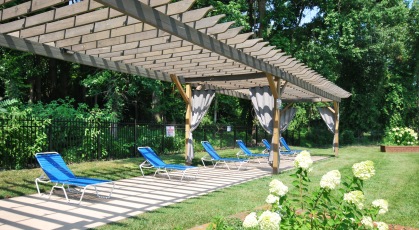 Pergola with social area and lounge seating by the pool