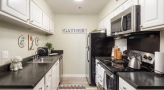Kitchen with black countertops and stainless steel appliances