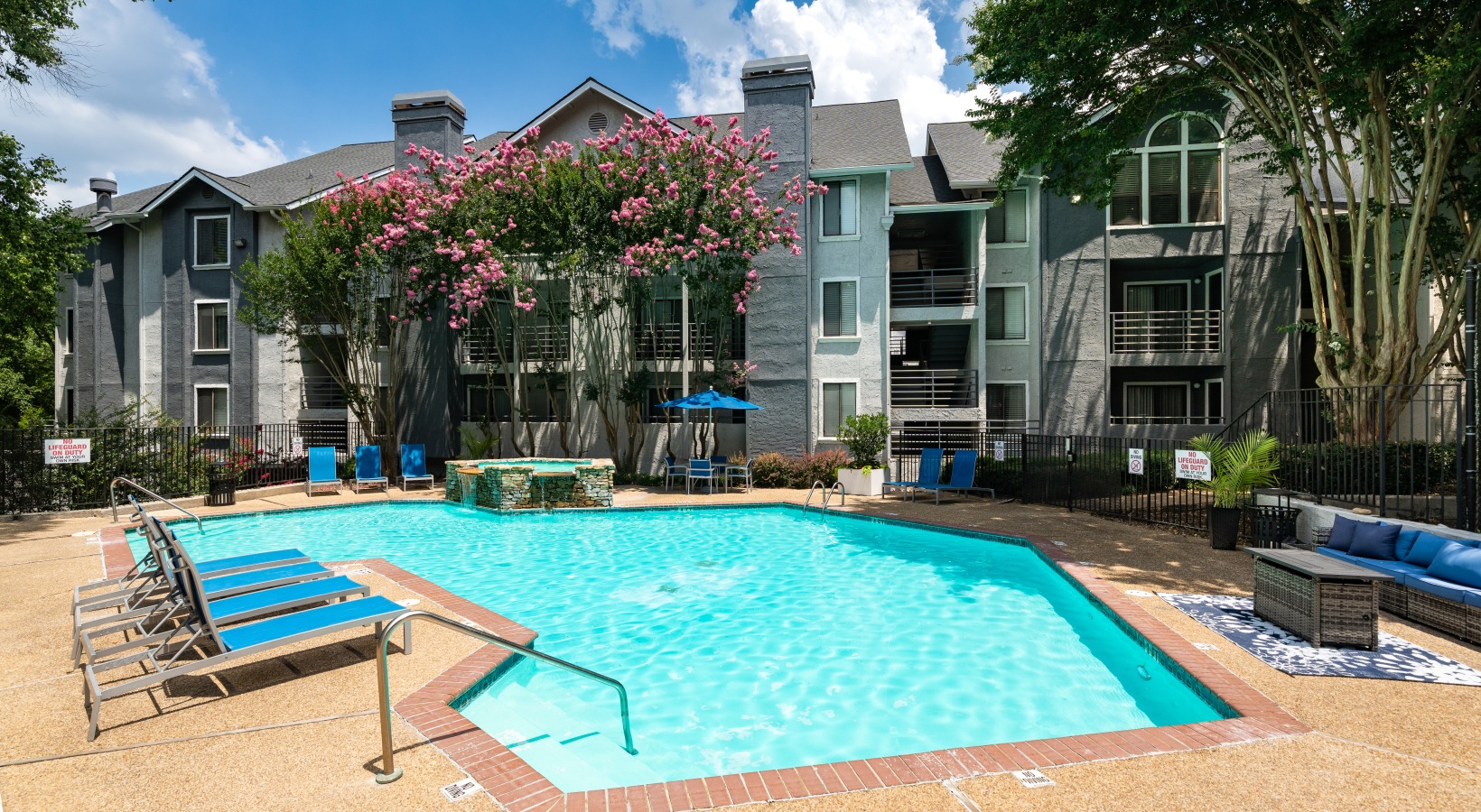 Swimming pool with lounge seating and umbrellas