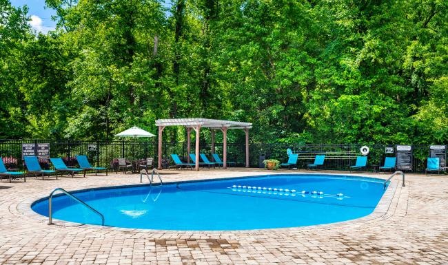 a swimming pool with chairs around it