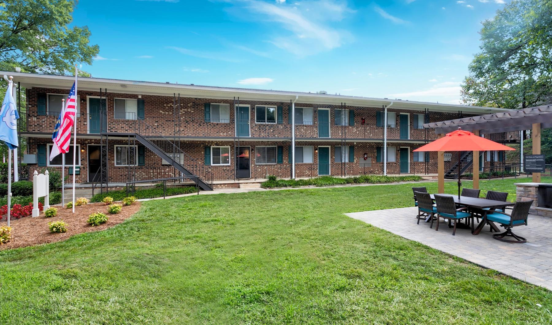 a building with a lawn and chairs