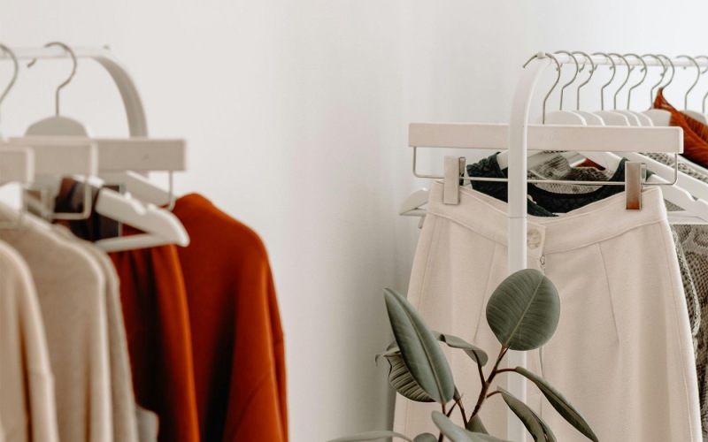 clothes on a rack near a plant