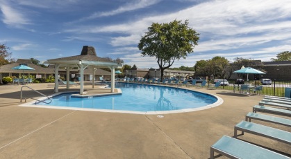 Swimming pool with lounge seating and umbrellas