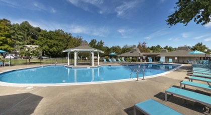 Swimming pool with lounge seating and umbrellas