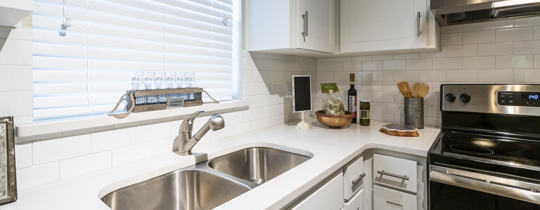 a kitchen with white cabinets