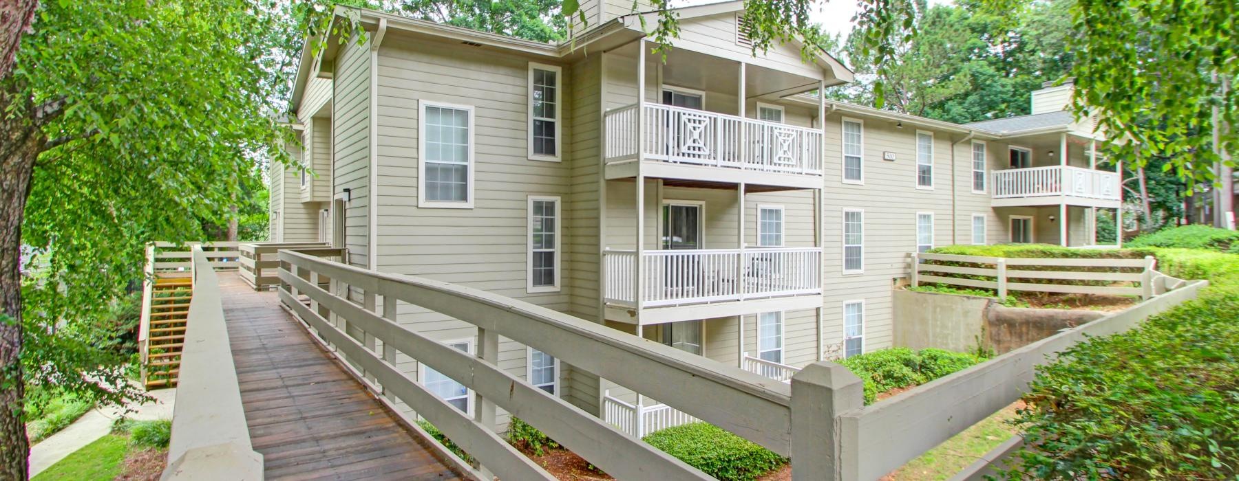 a wooden walkway leading to a building