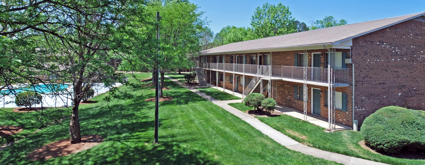 a building with a lawn and trees