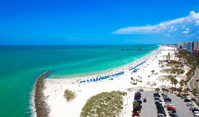 a beach with cars and people