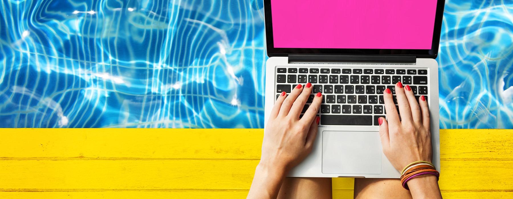 a pair of hands holding a laptop