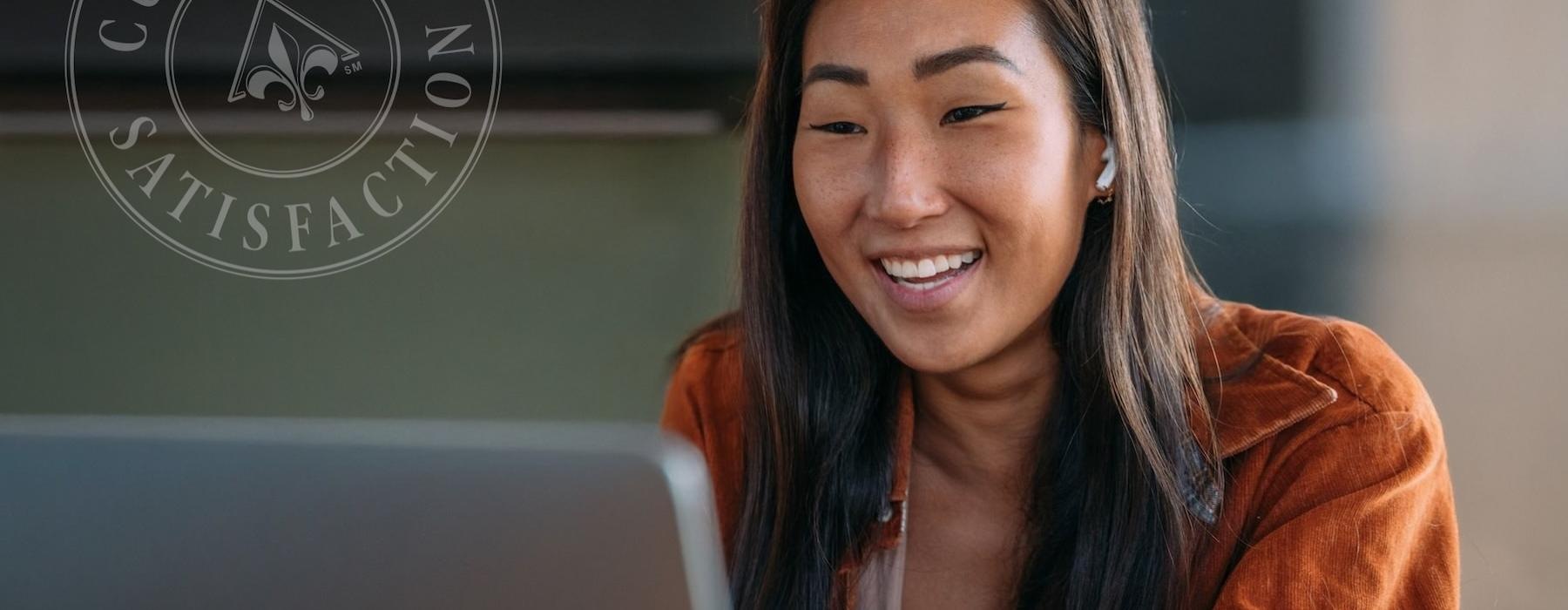 a woman smiling at the computer