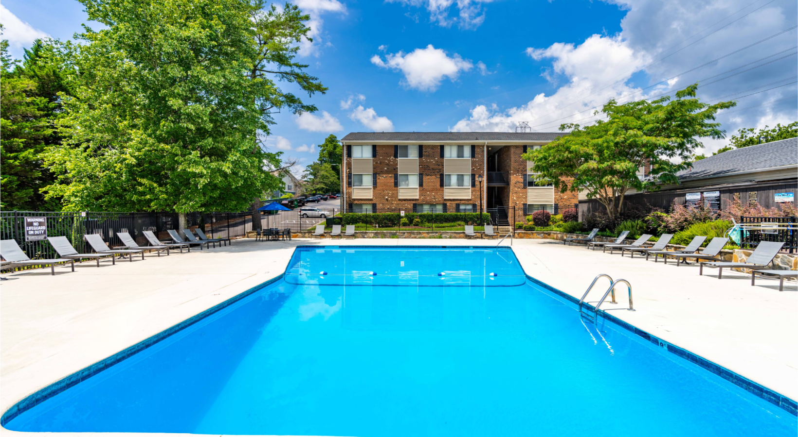 Main pool at Duke manor with lounge seating and umbrellas