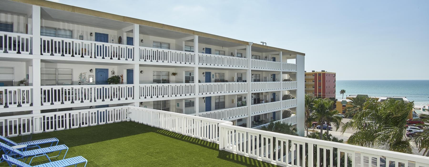 a building with a lawn and chairs