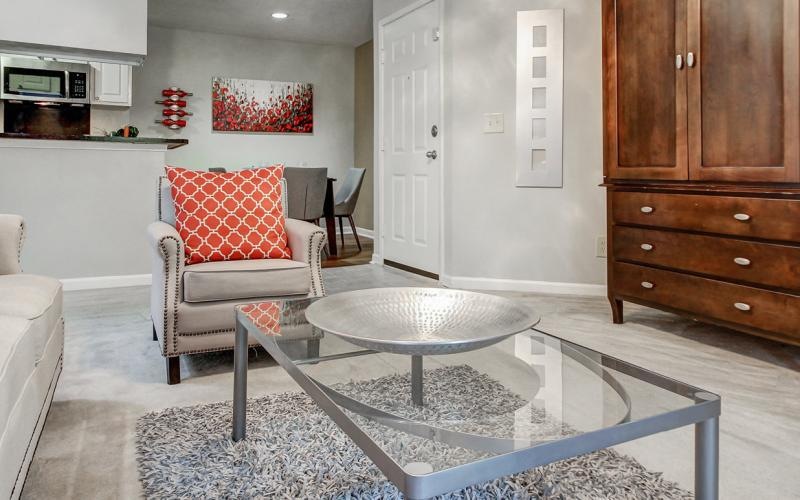 a living room with a table and chairs