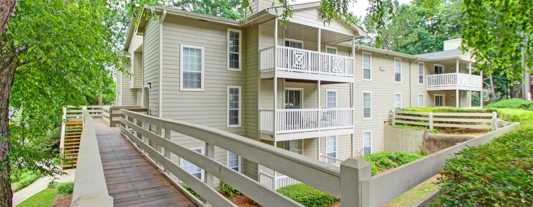 a wooden walkway leading to a building