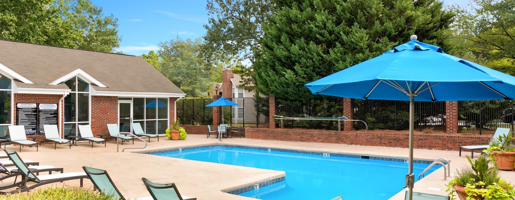 a pool with chairs and umbrellas
