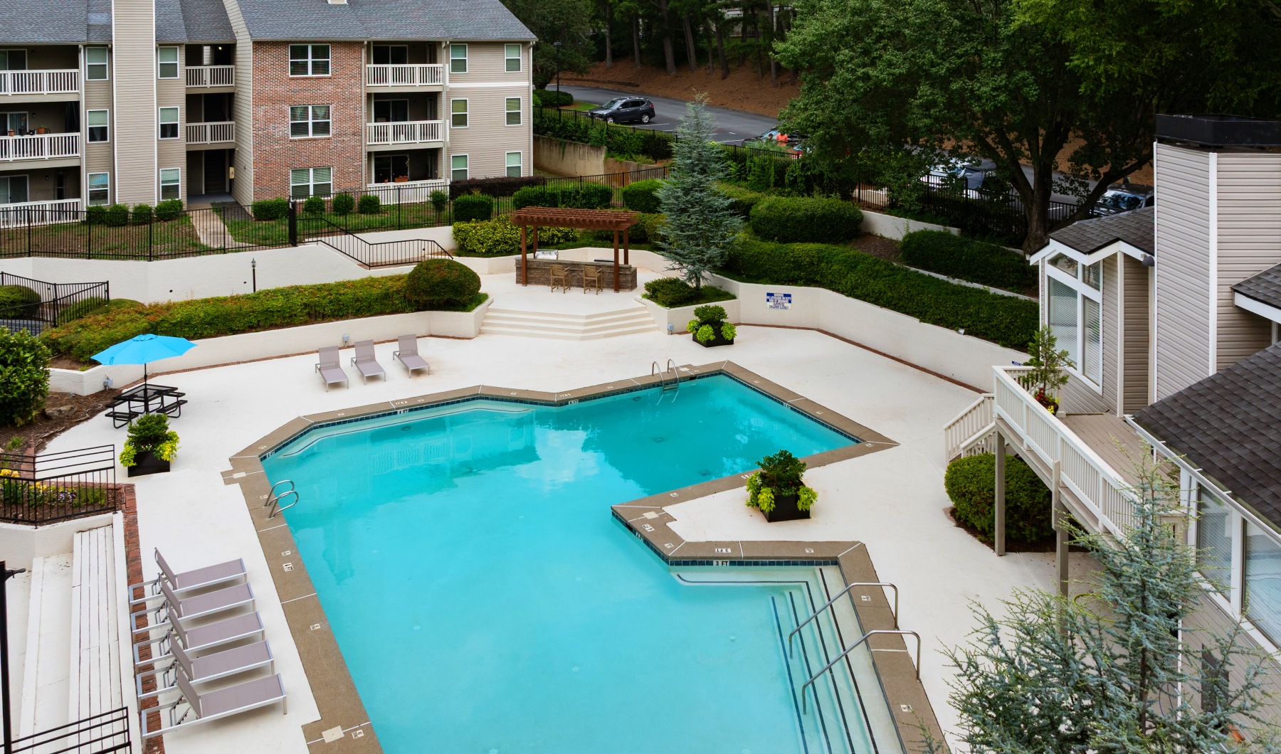 Pristine pool with custom stone gas grills