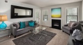 Living room with fireplace and balcony access