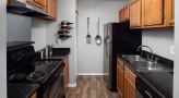 Efficient galley kitchen featuring premium stainless steel appliances