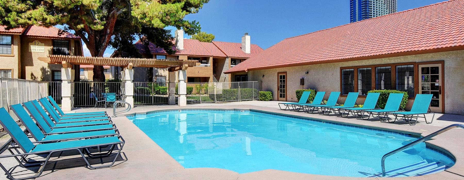 a swimming pool with lounge chairs
