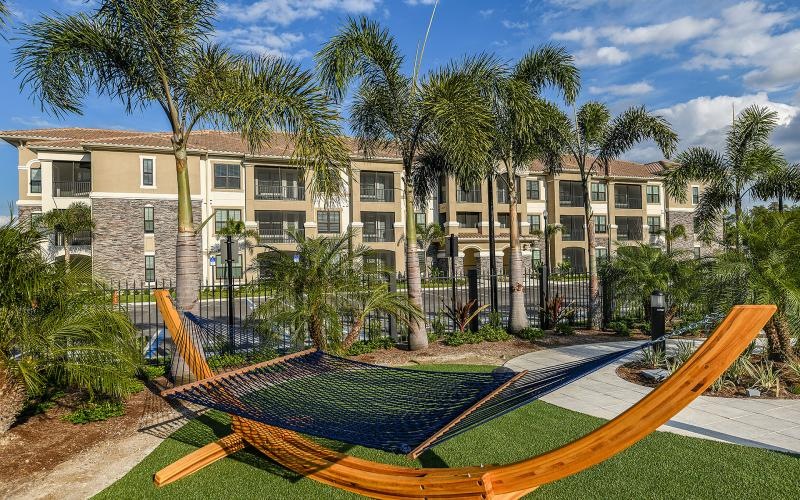 a building with trees and a trampoline in front of it