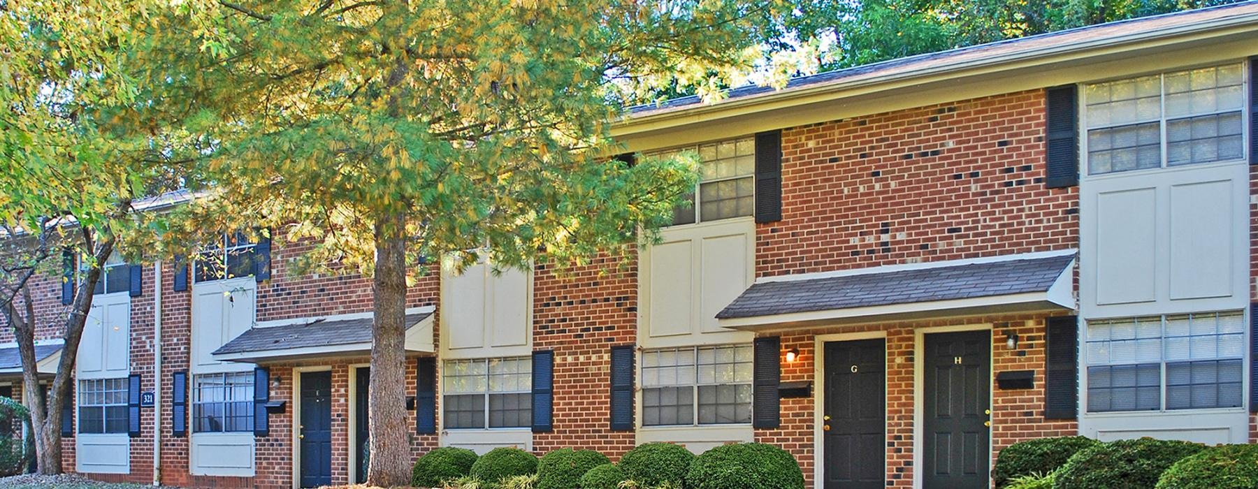 a brick building with trees in the front