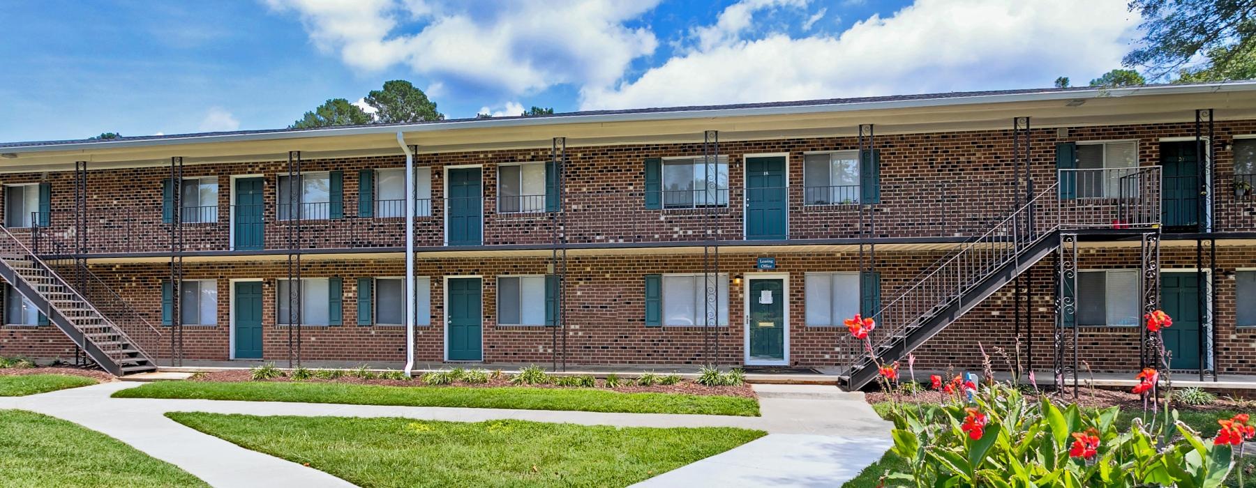 a building with a walkway and grass
