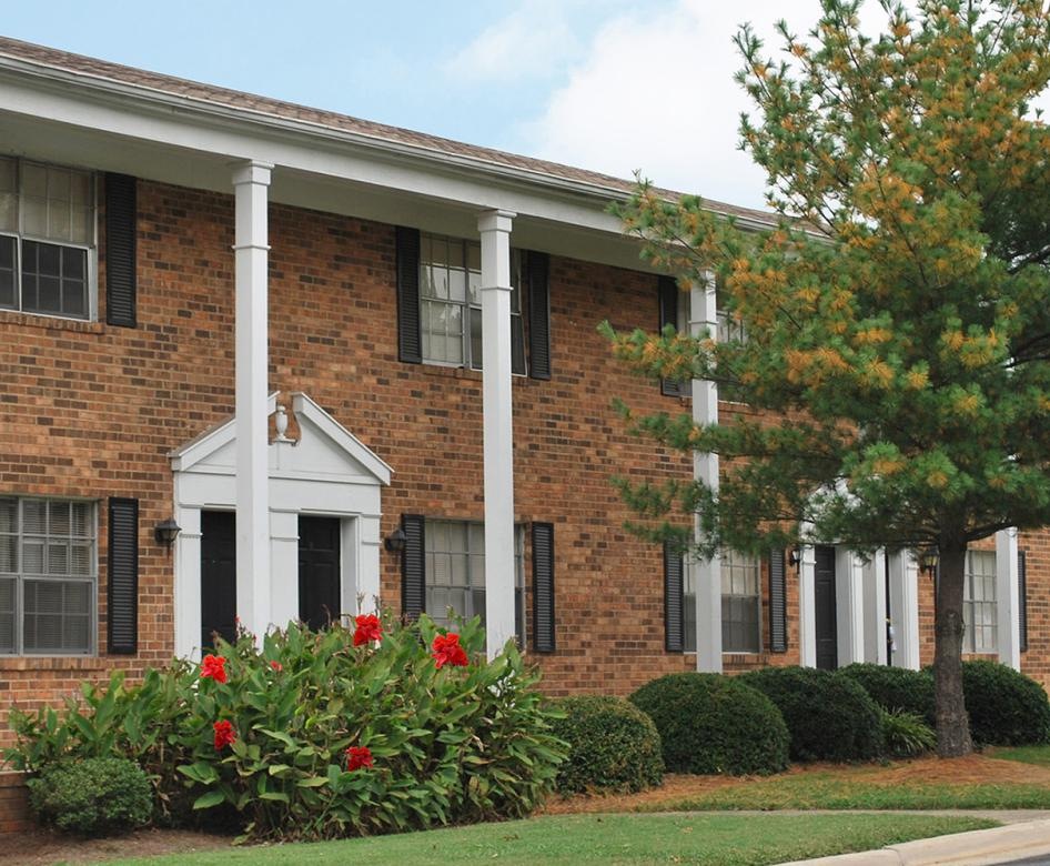 a brick building with a white column