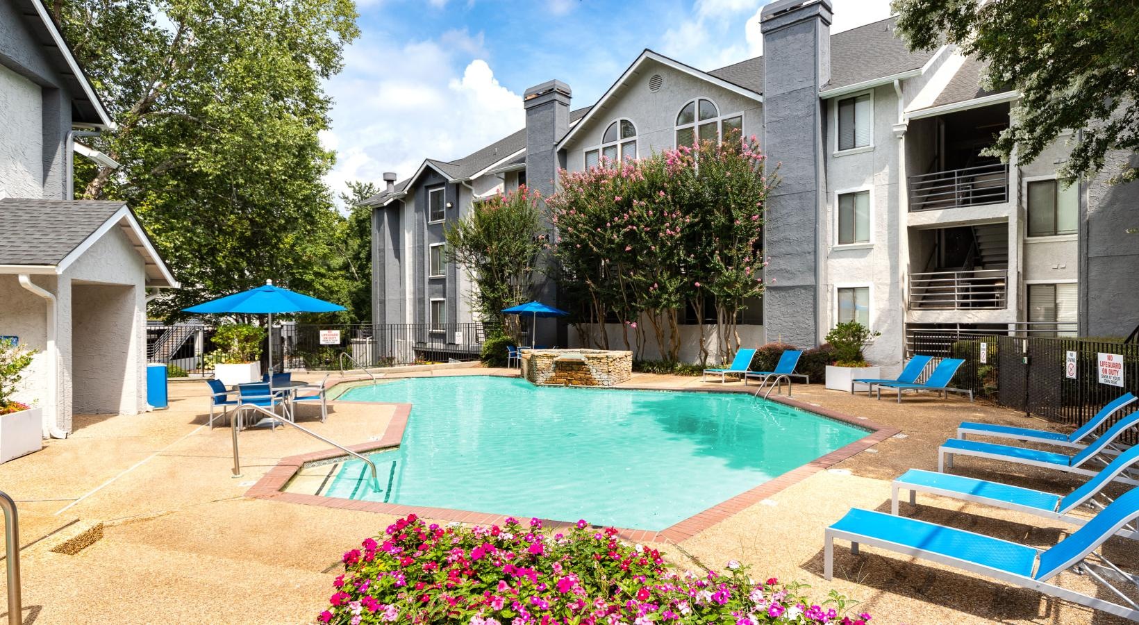 Swimming pool with lounge seating and umbrellas