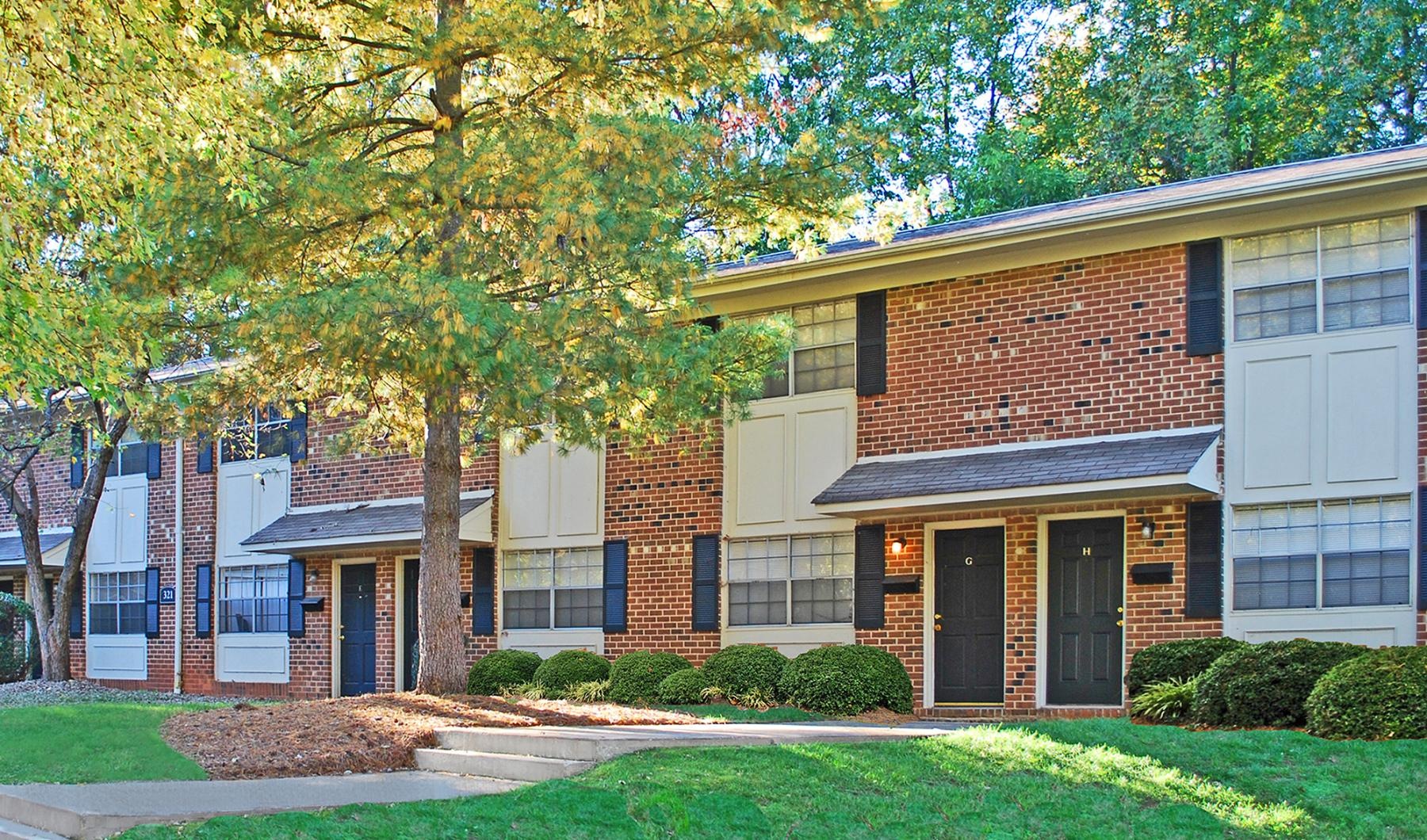 a brick building with trees in the front