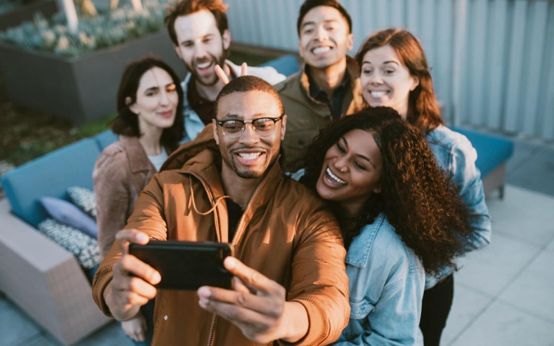 friends take a group selfie outdoors